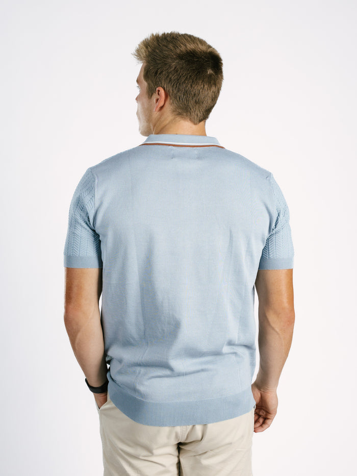 Light blue Georgia Southern men's ribbed polo shirt by Arena Graffiti, featuring the "GS" logo on the chest.