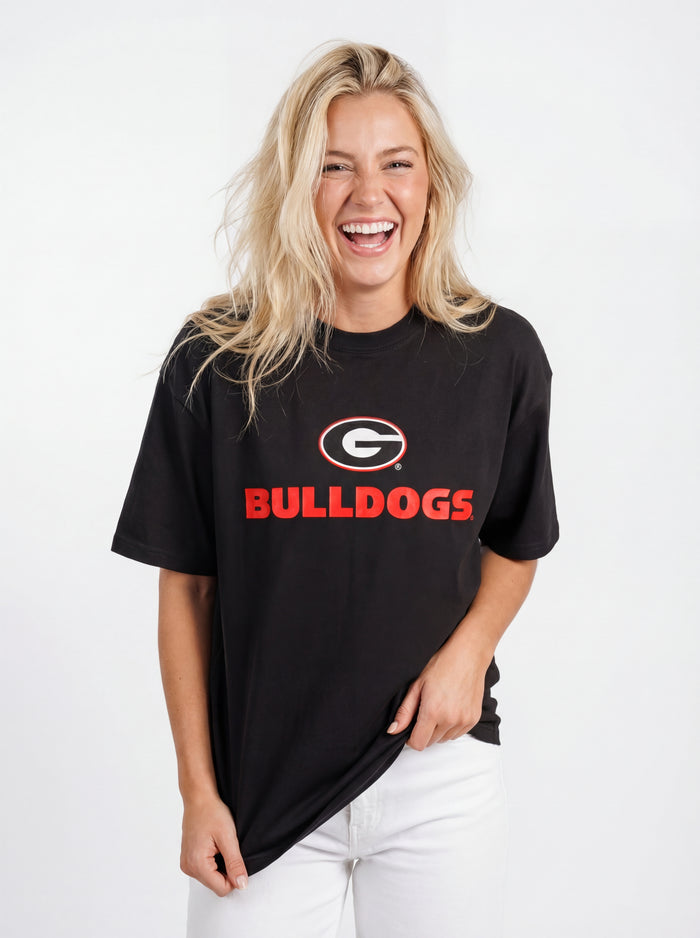 UGA Bulldogs Women's Bulldog Heavyweight Tee by Arena Graffiti, showing a navy blue T-shirt with Bulldogs logo and team graphics.